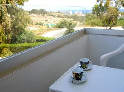 two coffee cups on a balcony with a view at Napa City Apartments in Ayia Napa