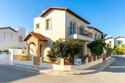 a large white house on a street at Villa Francesca in Paralimni