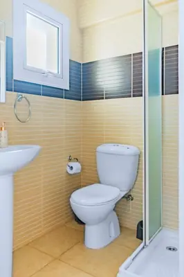 a bathroom with a toilet and a sink at Villa Francesca in Paralimni