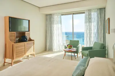 a hotel room with a bed and a television at Sunrise Jade - Adults Only in Protaras
