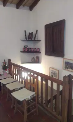a dining room with a table and chairs on a wall at Patriko Traditional House in Kakopetria