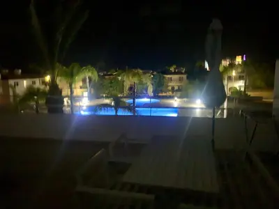 a view of a pool at night with lights at Nissi Sandy Bay C09 in Ayia Napa