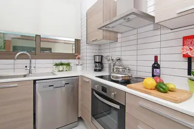 a kitchen with a cutting board with fruit on a counter at Villa Serena in Protaras