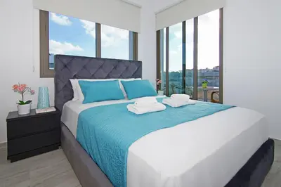 a bedroom with a large bed with two towels on it at Villa Serena in Protaras
