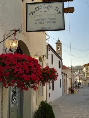 a sign for the old coffee shop with red flowers at Saint Antonio Maroni in Maroni