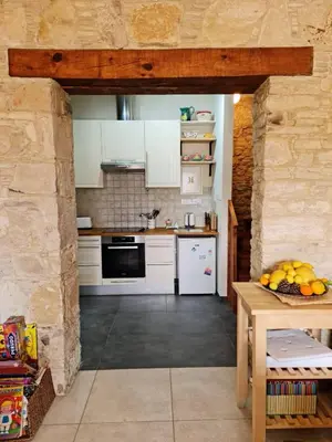 a kitchen with white appliances and a table with fruit at Haven in Limassol