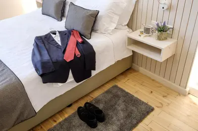 a bedroom with a bed with a suit on it at Limassol Old Town Mansion in Limassol