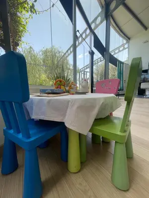 a table with two chairs and a table with a tablecloth at VILLA CATALEYA Fig Tree Bay Protaras Town Center in Protaras
