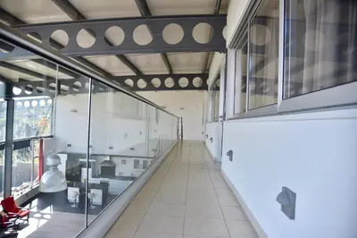 an empty hallway in a building with glass windows at VILLA CATALEYA Fig Tree Bay Protaras Town Center in Protaras