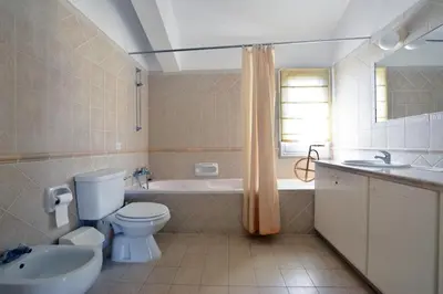 a bathroom with a toilet and a tub and a sink at Villa Daryah Sirina Bay in Protaras