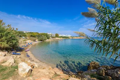 a beach with a group of people laying on the shore at Villa Daryah Sirina Bay in Protaras