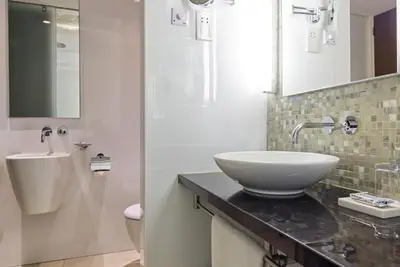 a white bathroom with a sink and a mirror at Sunrise Pearl Hotel & Spa in Protaras