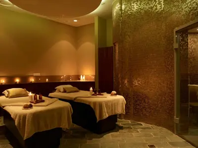 a room with two beds and a shower at Sunrise Pearl Hotel & Spa in Protaras