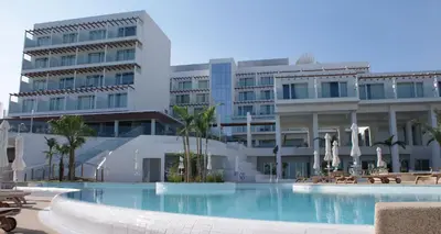 a hotel with a swimming pool in front of a building at Sunrise Pearl Hotel & Spa in Protaras