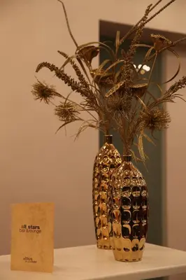 two vases with flowers in them sitting on a table at Altius Boutique Hotel in Nicosia