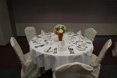 a table with a white table cloth and a vase of flowers at Altius Boutique Hotel in Nicosia