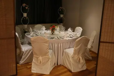 a white table with white chairs and a white table with flowers at Altius Boutique Hotel in Nicosia