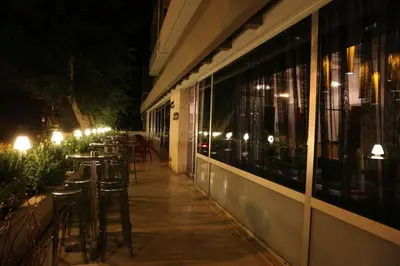 a row of tables and chairs outside of a restaurant at night at Altius Boutique Hotel in Nicosia