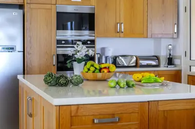 a kitchen with a counter with fruits and vegetables on it at Protaras Beachfront Villa Pietra in Protaras