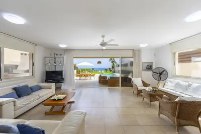 a living room with couches and chairs and a table at Protaras Beachfront Villa Pietra in Protaras