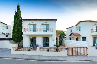 a white house with a fence at Villa Rosita in Paralimni