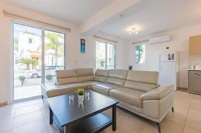a living room with a couch and a table at Villa Rosita in Paralimni