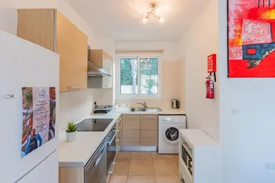 a kitchen with a sink and a washing machine at Villa Rosita in Paralimni