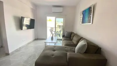 a living room with a couch and a table at Napa Court 2 in Ayia Napa