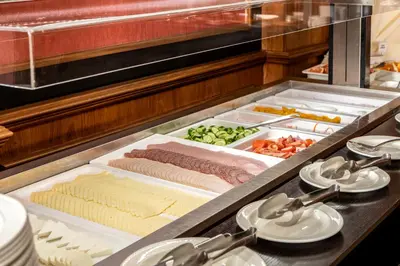 a kitchen with many different types of food at Kapetanios Limassol Hotel in Limassol