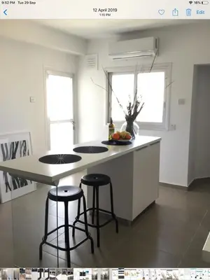a kitchen with a island with two stools in it at RESIDENCE ONE in Limassol