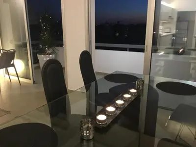 a dining room with a glass table with candles on it at RESIDENCE ONE in Limassol