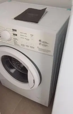 a white washing machine sitting on top of a counter at RESIDENCE ONE in Limassol