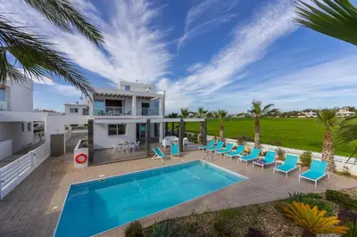 an image of a villa with a swimming pool at Faros BeachFront Villa in Pervolia