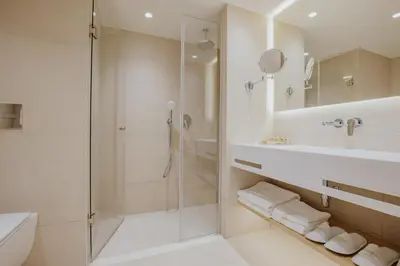 a bathroom with a shower and a toilet and a sink at Golden Coast Beach Hotel in Protaras