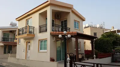 a large building with a porch and balcony at Philippou Beach Villas & Apartments in Larnaka