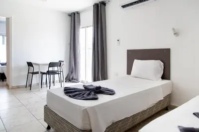 a bedroom with a bed and a table and chairs at Summer's Hotel Apartments in Ayia Napa