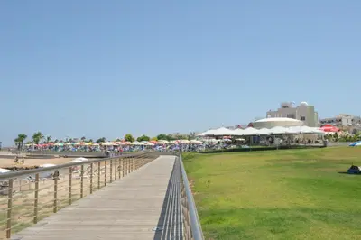 a boardwalk over a beach with a crowd of people at Polyxenia Isaak Luxury Villas and Apartments in Protaras