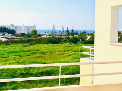 a view of a green field from a building at Nissi Elena A11 in Ayia Napa