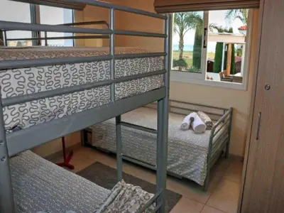 a bunk bed room with two bunk beds and a window at Villa Anastasia in Ayia Napa
