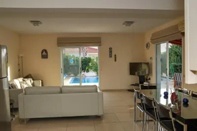 a living room with a couch and a table at Villa Anastasia in Ayia Napa