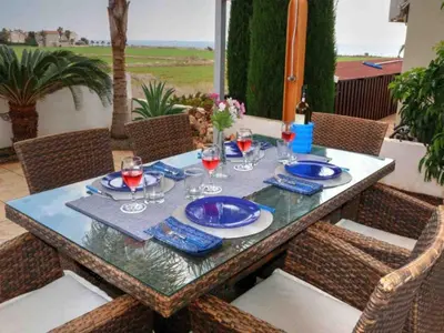 a table with glasses of wine on a patio at Villa Anastasia in Ayia Napa