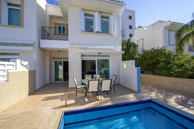 a villa with a swimming pool and a house at Protaras Villa Marilia in Protaras