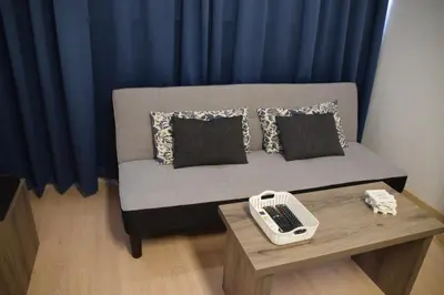 a room with a couch with a phone on a table at Sea Krystel 603 in Larnaka