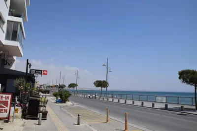 an empty street next to a beach with the ocean at Sea Krystel 603 in Larnaka