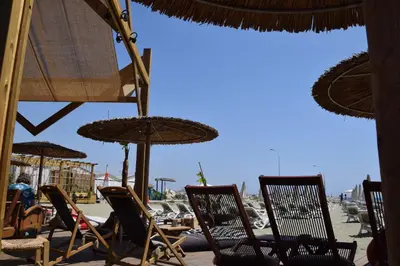 a group of chairs and umbrellas on a beach at Sea Krystel 603 in Larnaka