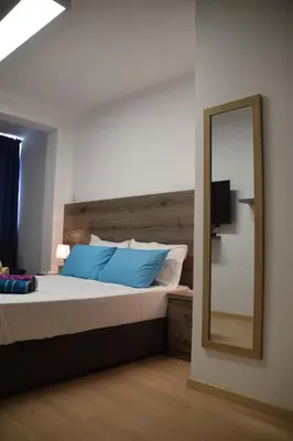 a bedroom with a large bed and a mirror at Sea Krystel 603 in Larnaka