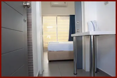 a bathroom with a sink and a tub in a room at St. George Rent Rooms in Larnaka