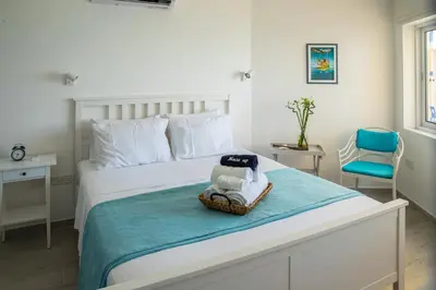 a bedroom with a bed with a towel on it at Front-Row - Skyline Retreat - Pool Access in Larnaka