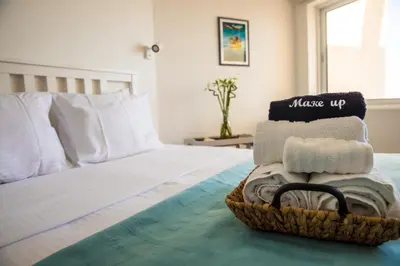 a basket of towels sitting on a bed at Front-Row - Skyline Retreat - Pool Access in Larnaka