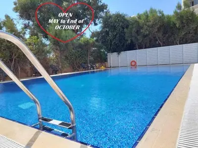 a large blue swimming pool with a heart on it at Front-Row - Skyline Retreat - Pool Access in Larnaka